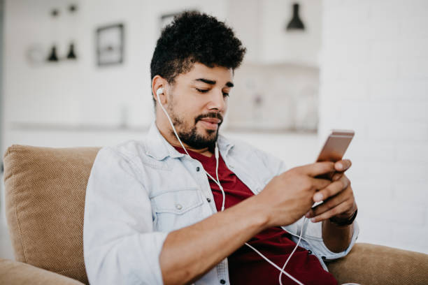 istock Young man typing text message on the phone 886841212