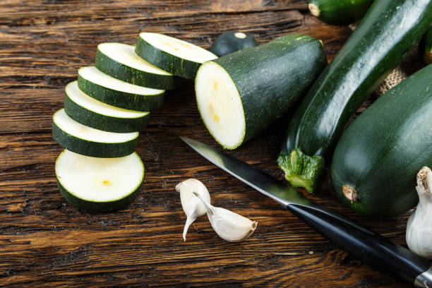 istock Whole and chopped zucchini on the kitchen table 886850208