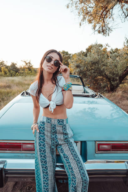 istock Girl posing on a background cabriolet 886851212