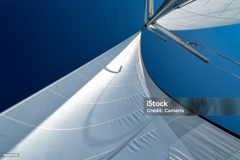 sails in the wind sails of a sailing yacht in the wind sailing on the ocean Sailing Stock Photo