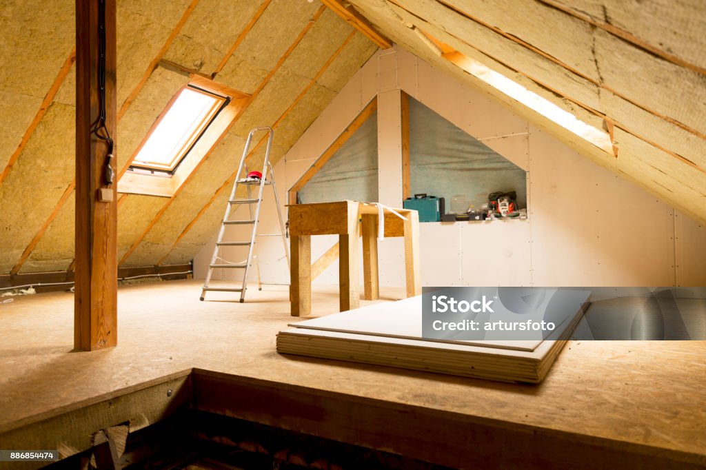 house attic under construction mansard wall insulation with rock wool Insulation Stock Photo