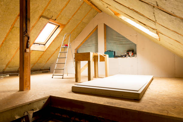 house attic under construction mansard wall insulation with rock wool stock photo