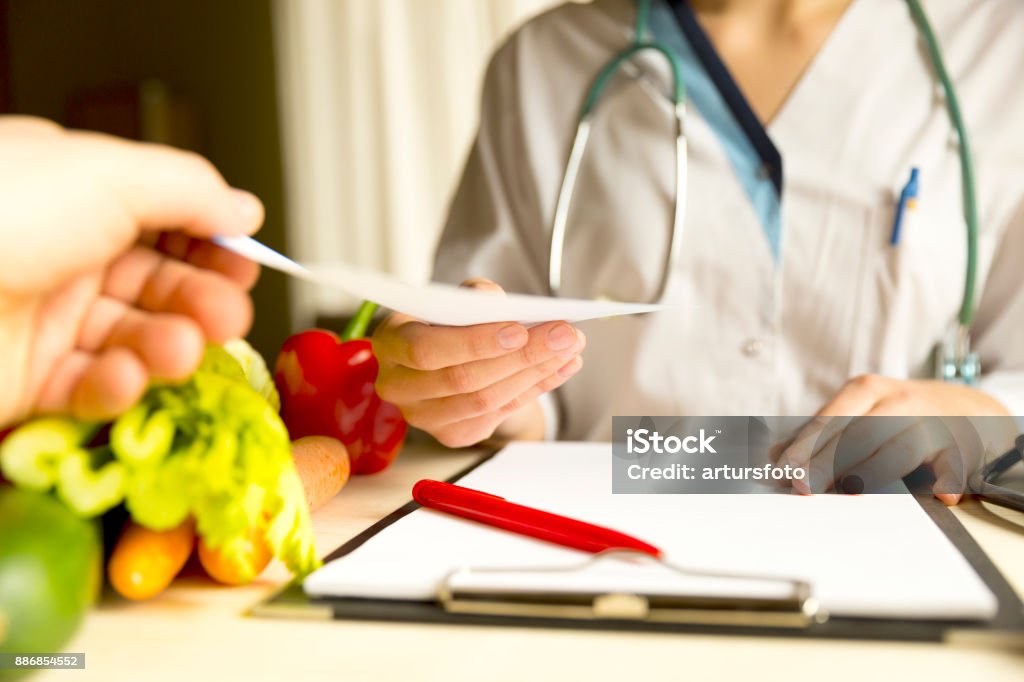 Vegetable diet nutrition and medication concept. Nutritionist offers healthy vegetables diet. Nutritionist Stock Photo