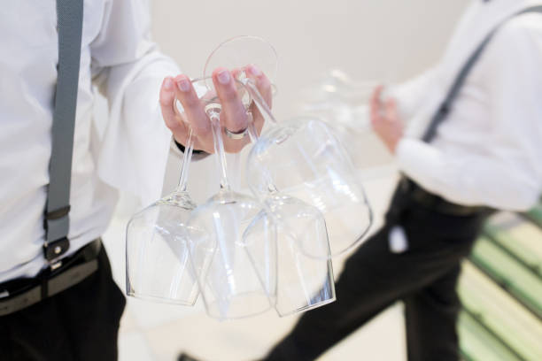Waiter holds glass in his hand