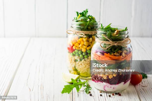 Healthy Homemade Salads With Chickpeas Bulgur And Vegetables In Mason Jars On White Wooden Background Stock Photo - Download Image Now