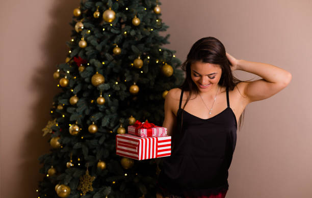 istock Woman holding Christmas presents 886858068