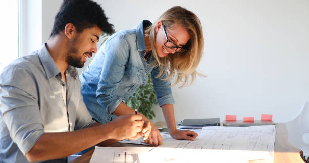 istock Coworkers working on project together in office 886875172