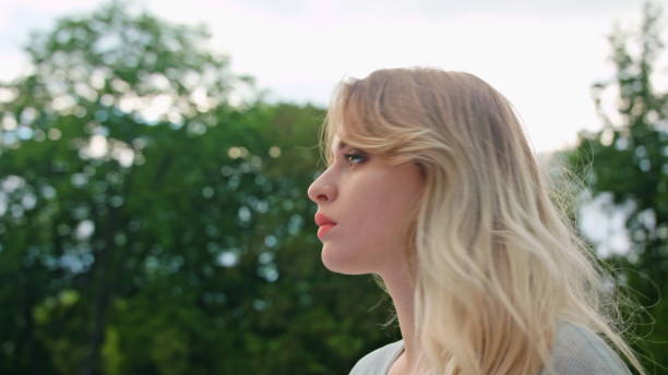 istock A Young Blonde Lady Turning Back her Head Outdoors 886878930