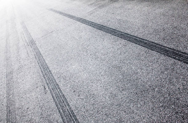 istock Wheel tracks on the road covered with hoarfrost 886879174