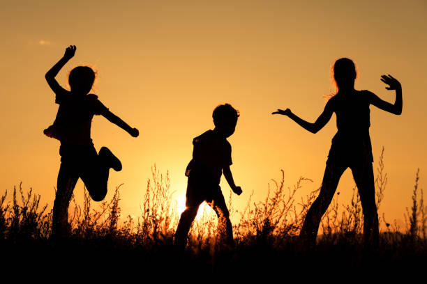 Silhouette of happy business human team making high hands over head in sunset sky evening time background for business teamwork concept and freedom