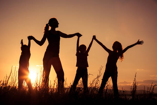 istock Happy family standing in the park. 886884248