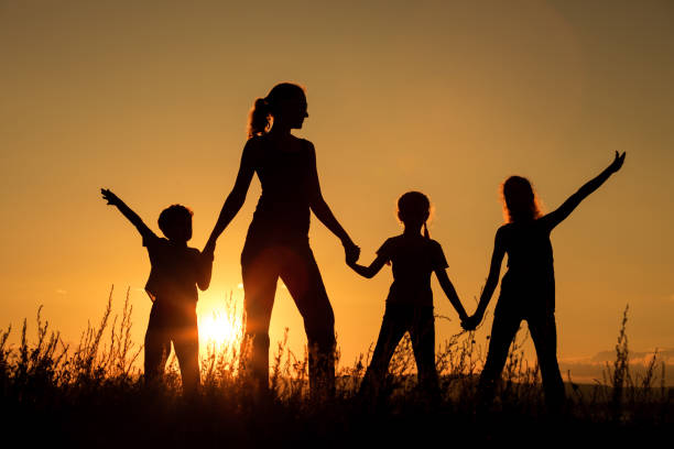 istock Happy family standing in the park. 886884380