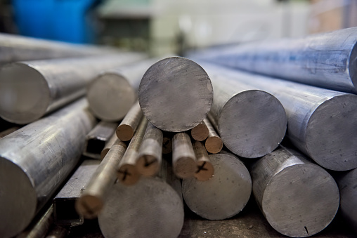Pile of aluminium rods. Metal bars close up. Buy aluminium online.