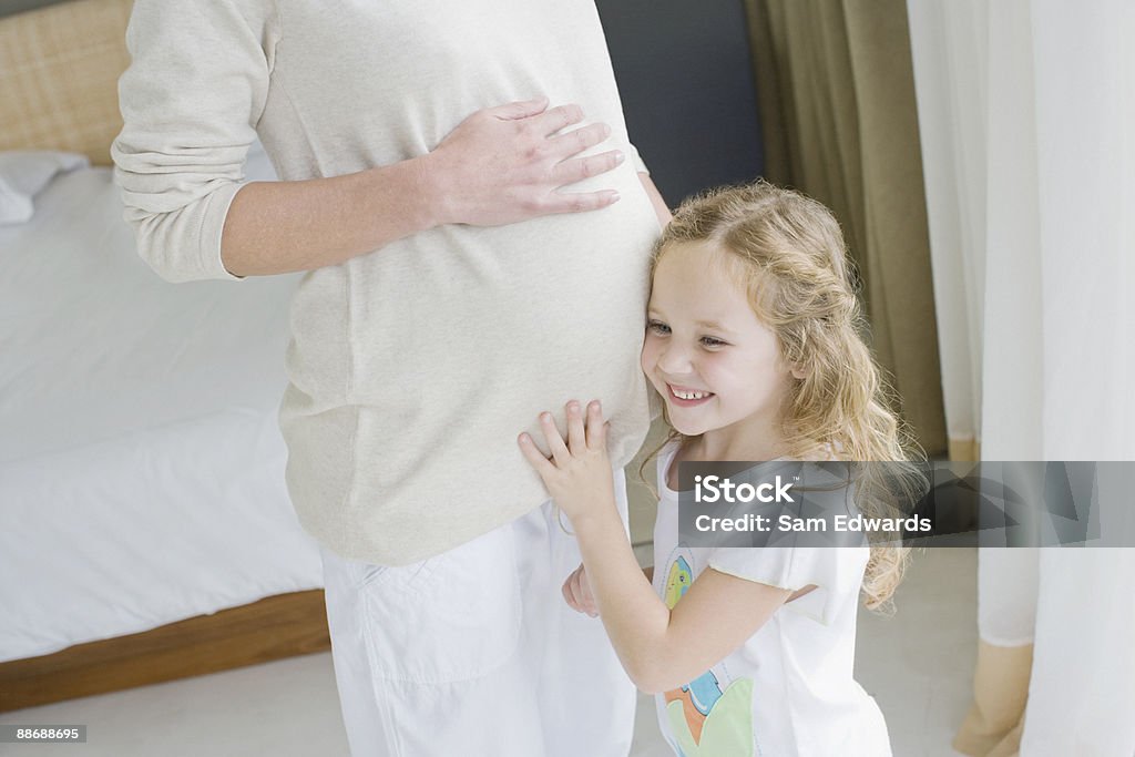 Filha de ouvir a barriga das mães grávidas - Foto de stock de 30 Anos royalty-free