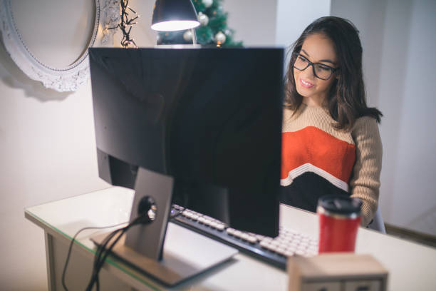 istock Businesswoman freelancer working at a computer at Christmas 886894578