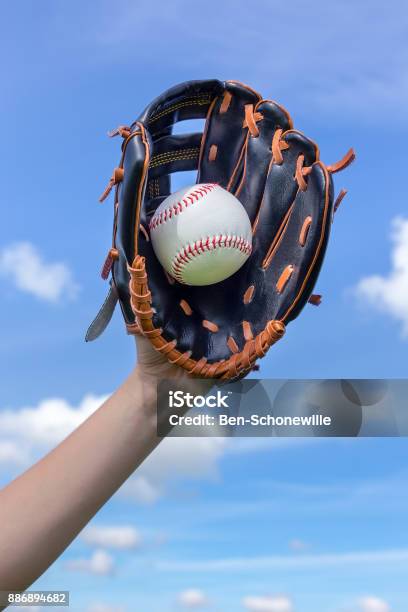 Arm Holding Baseball With Glove In Blue Sky Stock Photo - Download Image Now - Baseball - Ball, Baseball Glove, Glove