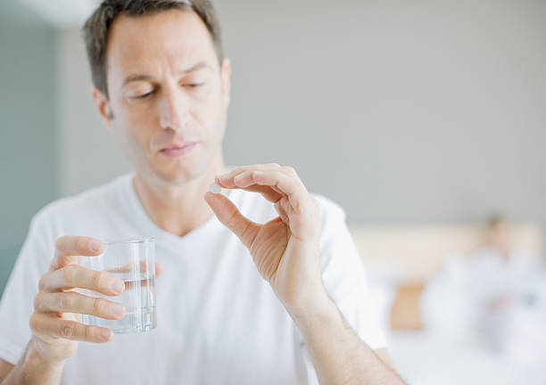 Man taking medicine  painkiller stock pictures, royalty-free photos & images