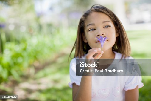 istock Young girl smelling flower 88689617