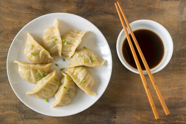 istock Eight boiled or fried jiaozi or gedza served with soy sauce. 886914170
