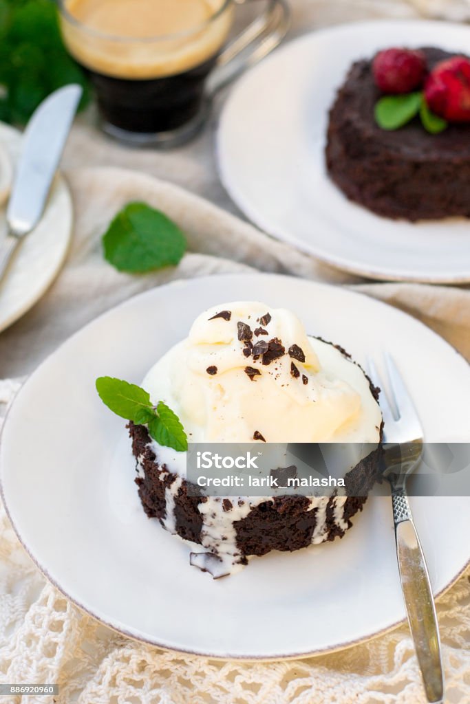 Molten chocolate cake fondant with vanilla ice cream and strawberry Molten chocolate cake fondant with vanilla ice cream and strawberry for dessert Baked Stock Photo