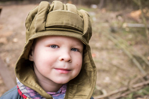 istock Little boy in a tank helmet 886926792