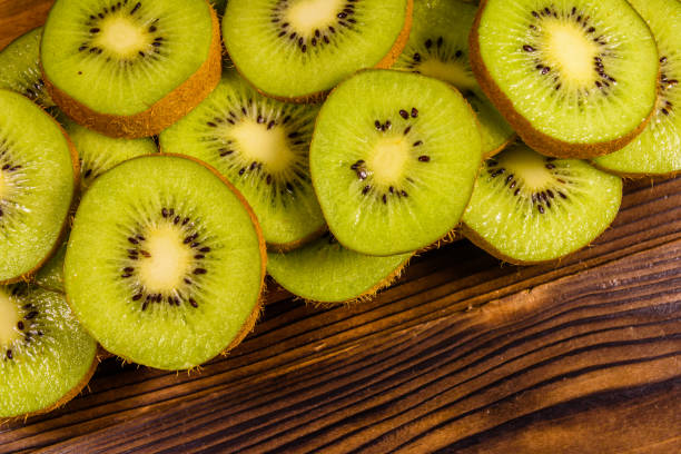 istock Kiwi fruits on wooden table. Top view 886930752