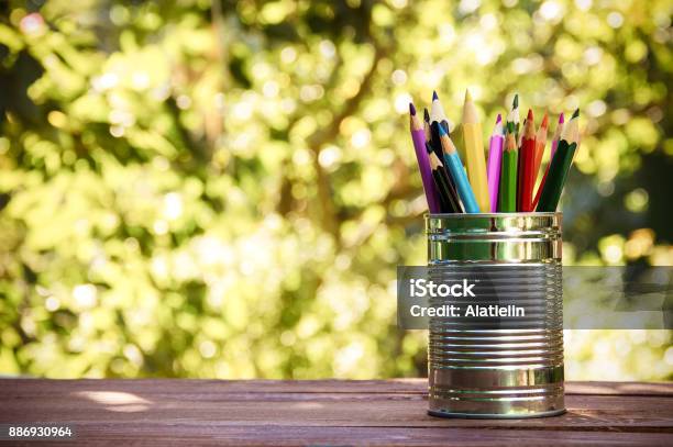 Iron Bank With Colored Pencils On A Wooden Table Ecostyle Copy Space Stock Photo - Download Image Now