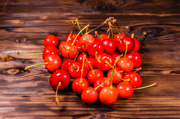 istock Fresh ripe cherries on wooden table 886930968