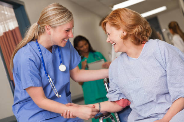 istock Young nurse talks with patient in wheelchair 886931432