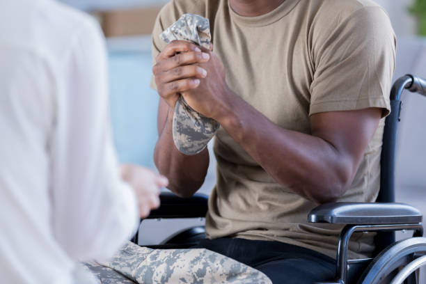 istock Wheel chair-bound veteran talks with psychiatrist 886933712