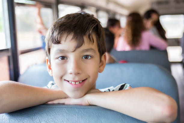 istock Handsome preteen boy on school bus 886933760