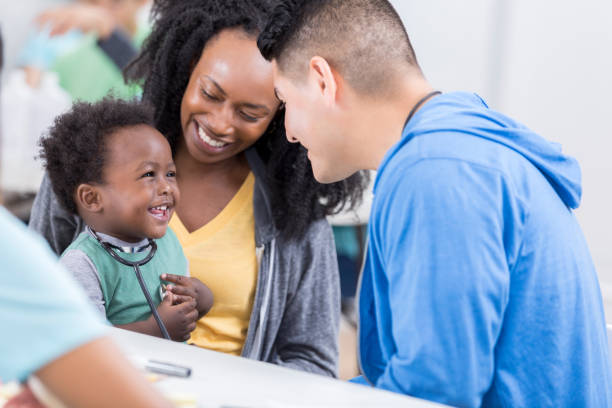istock Friendly volunteer pediatrician talks to baby boy 886933868