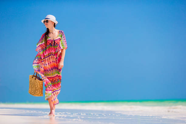 istock Young woman in hat during tropical beach vacation 886933894