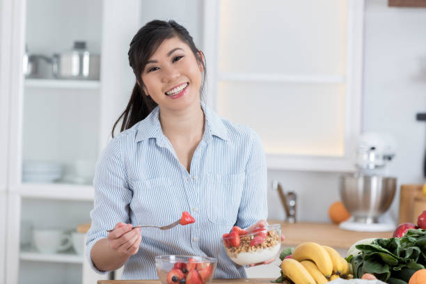 istock Young woman prepares organic fruit salad 886934348