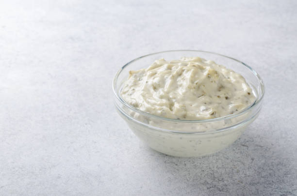 white sauce tartar tartare in a glass bowl on a light stone back - tartar sauce imagens e fotografias de stock