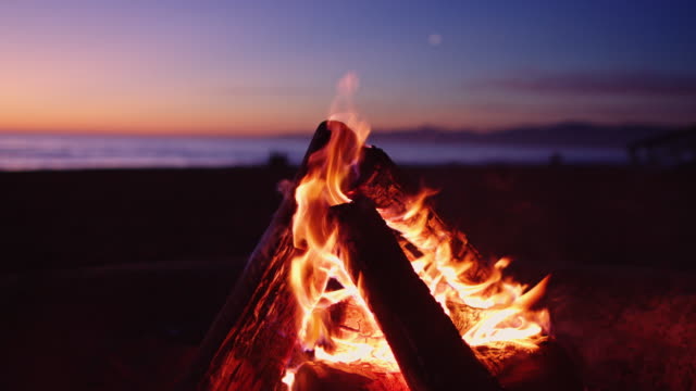 Fire Burning on Beach at Sunset