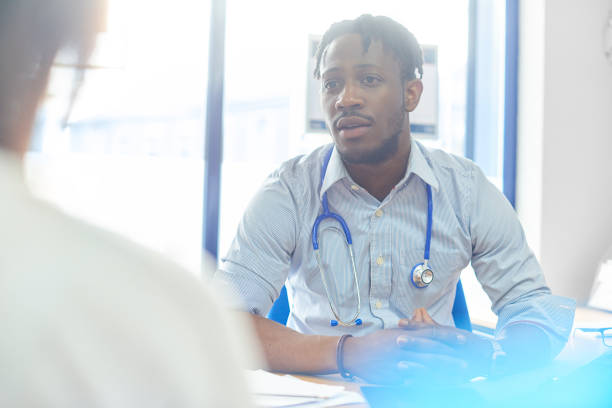 istock Junior doctor in consultation with patient 886942550