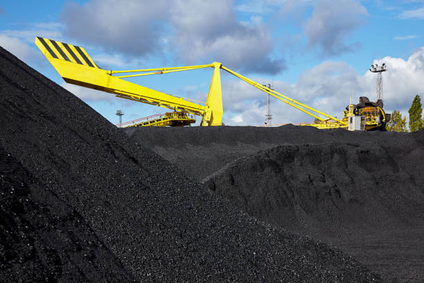 istock Heap of coal and excavator in coal mine 886942588