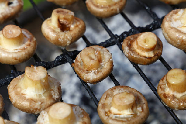 istock White champignons mushrooms on grill 886946014