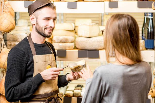 istock Cheese seller with a customer 886949426
