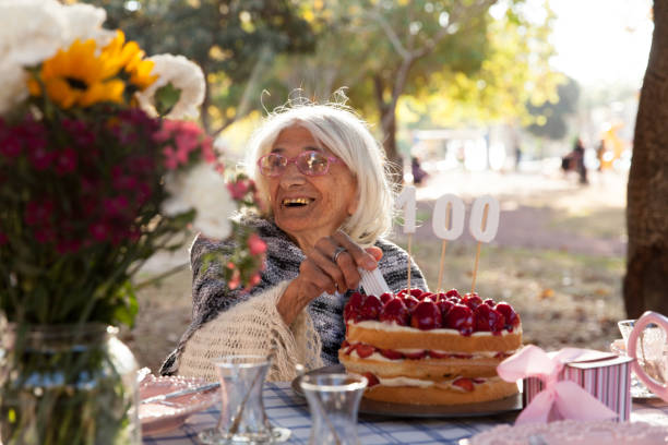 istock Senior women cutting cake 886949626