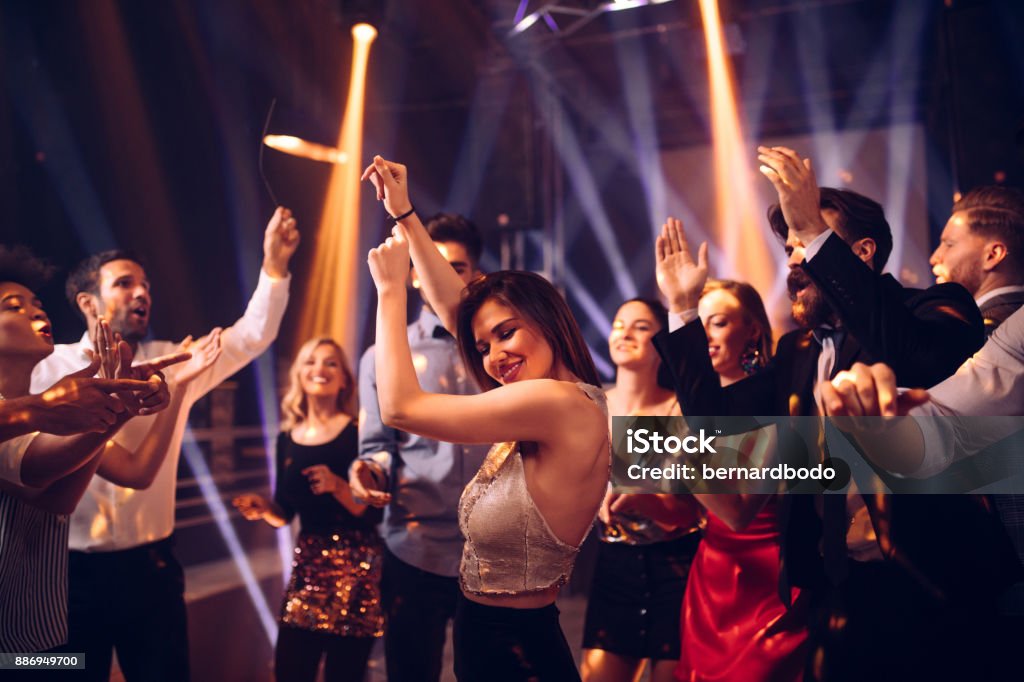 She's a party animal Shot of a young woman dancing in the nightclub Dancing Stock Photo