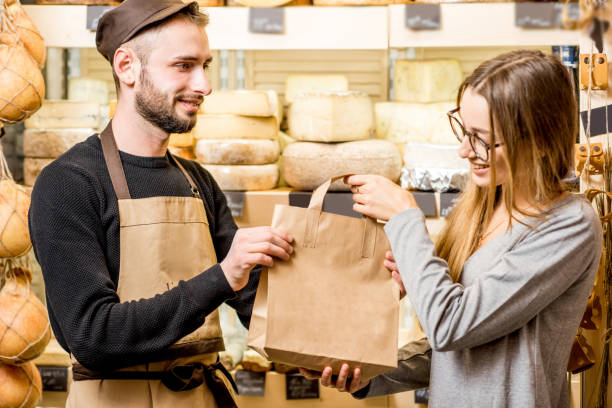 istock Cheese seller with customer at the shop 886949776