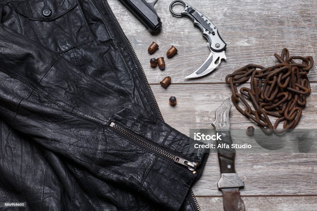 On The Floor Is A Leather Jacket A Chain Cartridges A Pistol And Two Knives  Stock Photo - Download Image Now - iStock