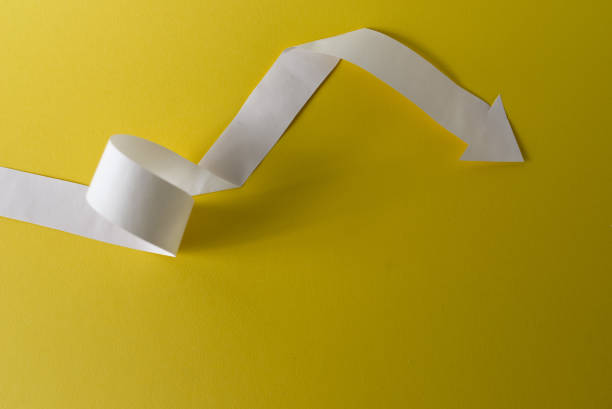 istock Origami paper arrow on yellow background 886959064