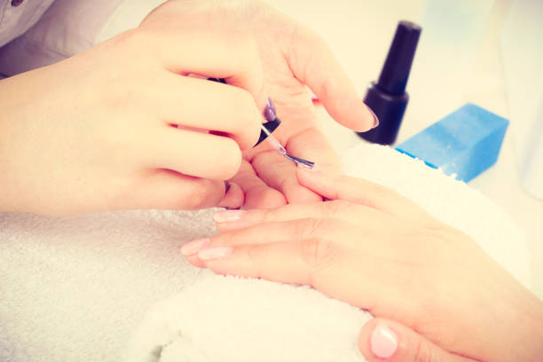 istock Close up of client and manicurist hands. 886963648