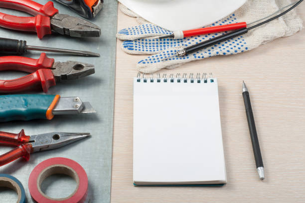 istock .Set of electrical tools, white helmet and notepad on metallic background. Energy concept. 886963766