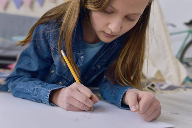 istock Talented child drawing on paper 886975348