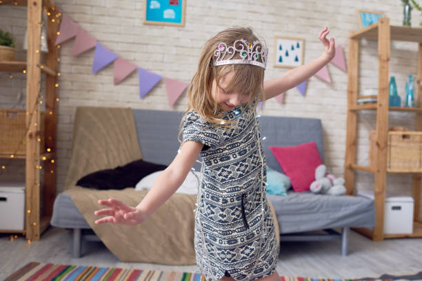 istock Little princess dancing in living room 886975644