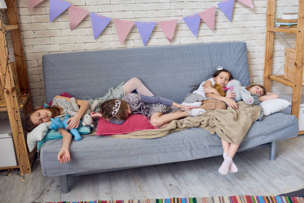 istock Cute friends sleeping after kids party 886977784